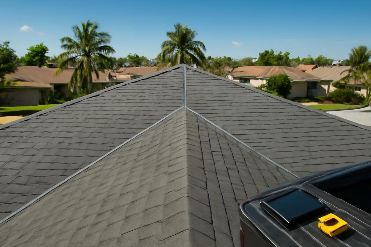 Precision measurements on laminated asphalt shingle roof with clear skies and palm trees